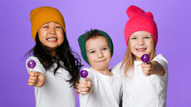 Three kids with purple lollies